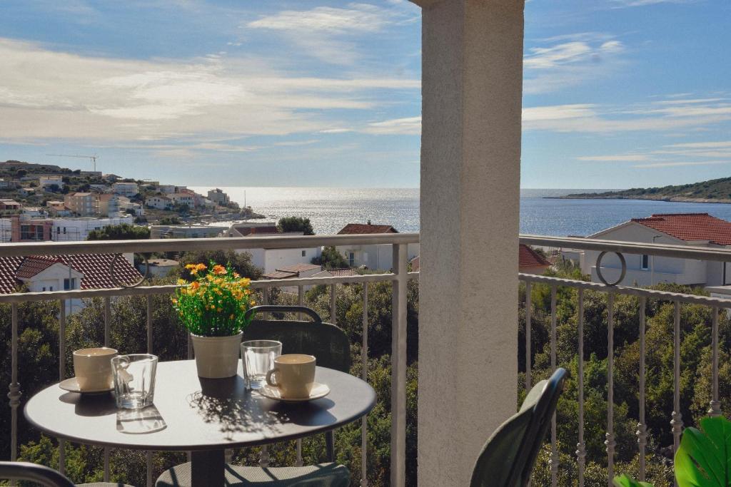 a balcony with a table with a view of the ocean at Sevid Seaview Apartments in Sevid