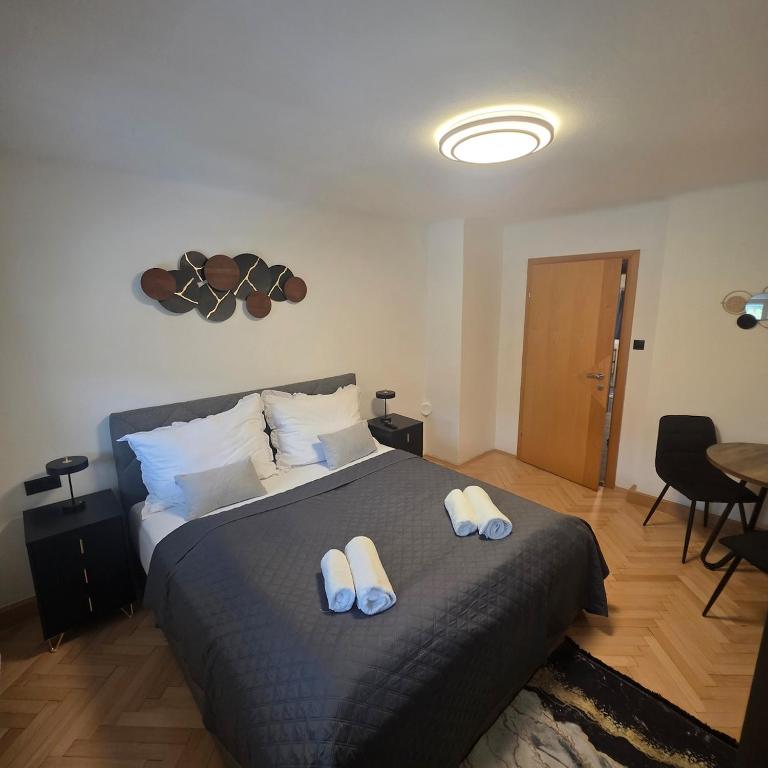a bedroom with a bed with two towels on it at Apartment Almblick in Übelbach