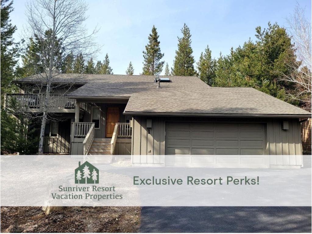 a house with a garage with a sign that reads summer resort exclusive resort rentals at 1 Fifteenth Tee Lane in Sunriver