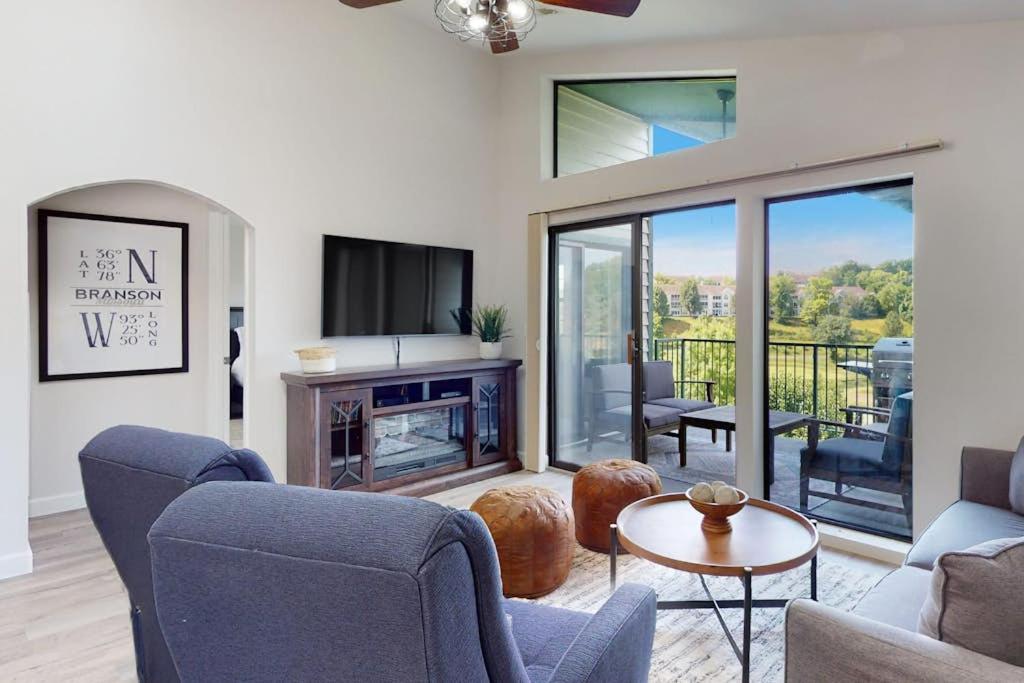 a living room with a couch and a fire place at Waterview Oasis in Branson