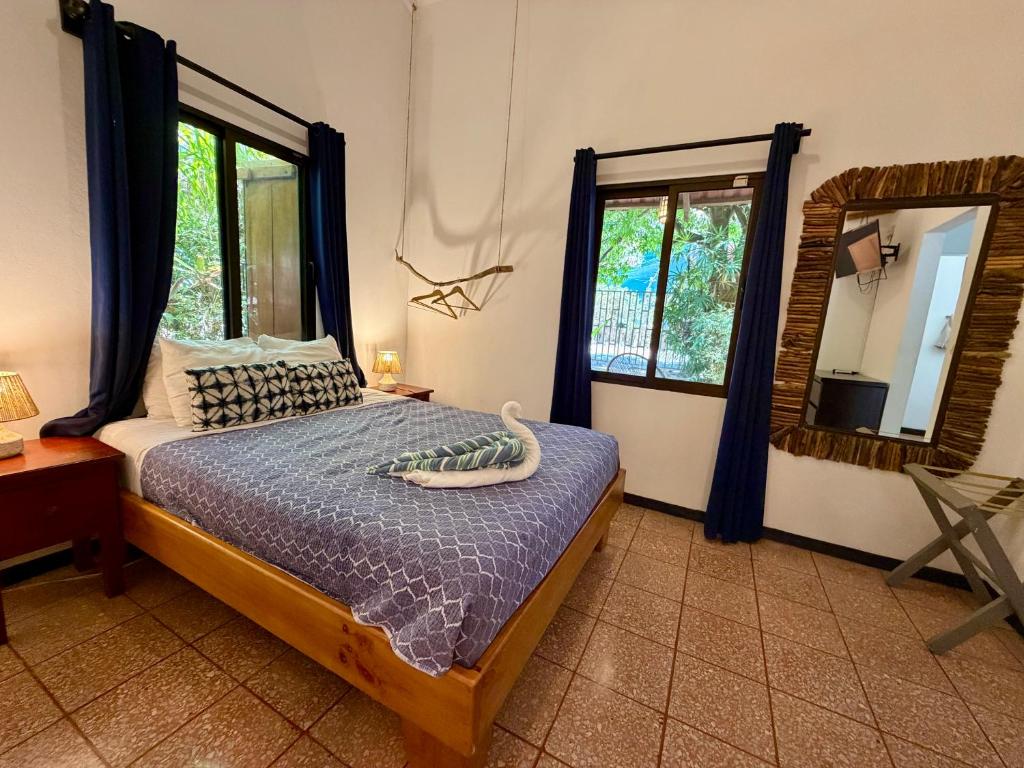 a bedroom with a bed and a large mirror at Casita Gitza in Montezuma