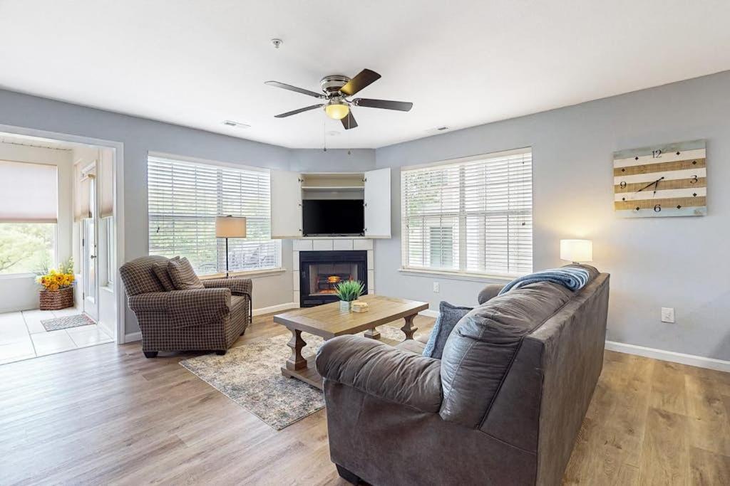 a living room with a couch and a fireplace at Hole in One in Branson