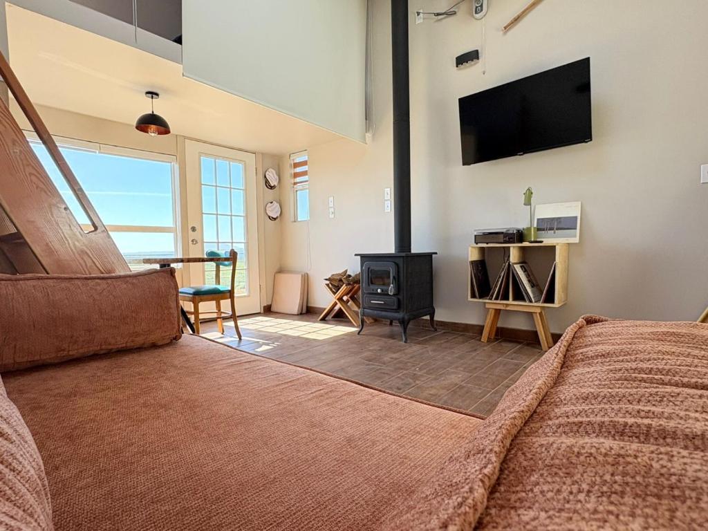 a bedroom with a bed and a flat screen tv at Casa Guilligan By Los Naufragos in El Bateque