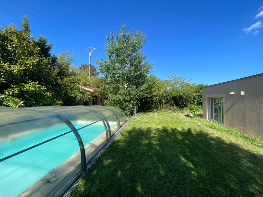 a swimming pool in the yard of a house at 15 min from Lyon Fresh Peaceful Room with Pool and Garden in Dardilly