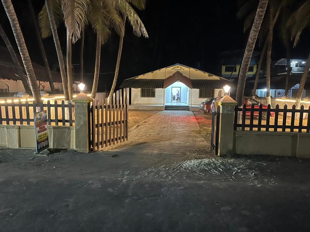 a gate in front of a house at night at Beach front in Murud