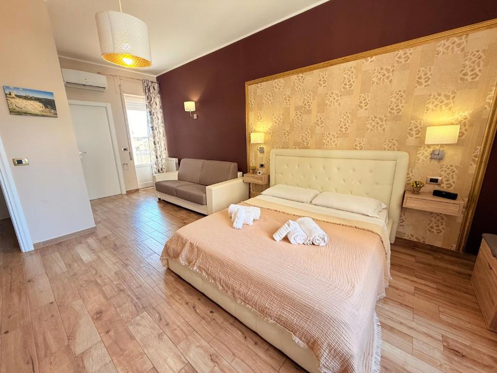 a bedroom with a bed with two towels on it at Home Syrakos in Syracuse