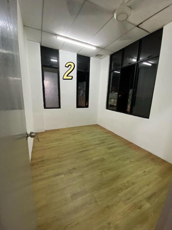 a room with a wooden floor and two windows at Top in Masai