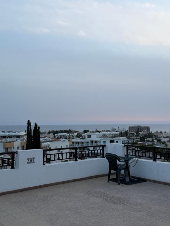 a black chair sitting on a balcony with a view at Venus sea view in Paphos