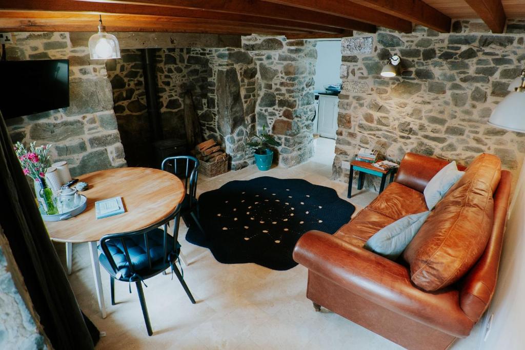 a living room with a couch and a table at Cliff Cottage in Cadgwith