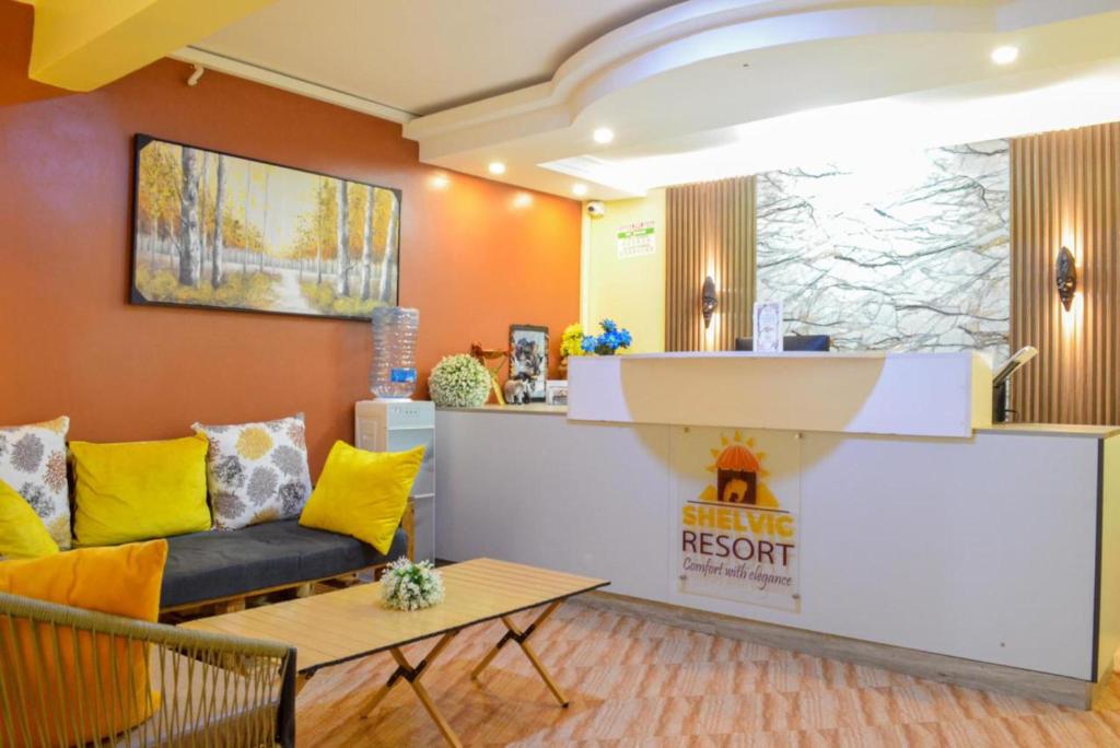 a waiting room with a couch and a counter at Shelvic Resort Ruiru in Ruiru