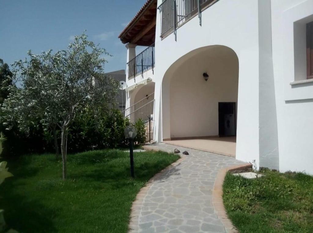 a courtyard of a white building with a walkway at Casa Dessi in Tanaunella