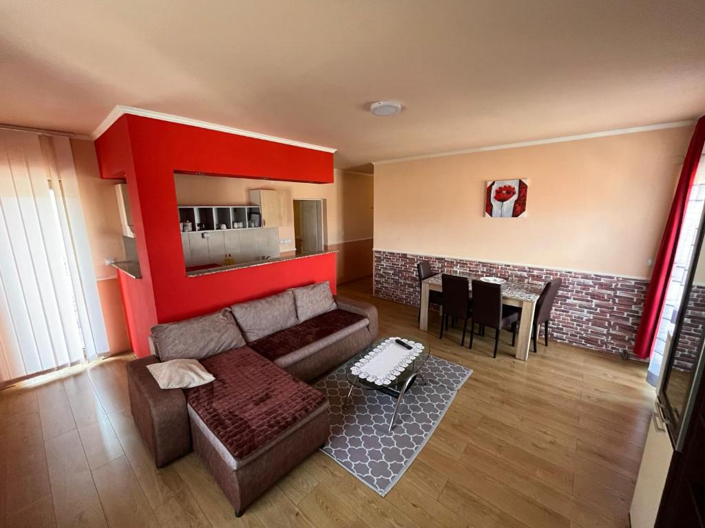 a living room with a couch and a table at Queen Apartmani in Soko Banja