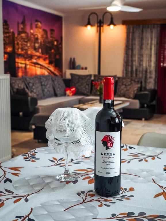 a bottle of wine sitting on a table with a glass at Comfort Stay in Preveza