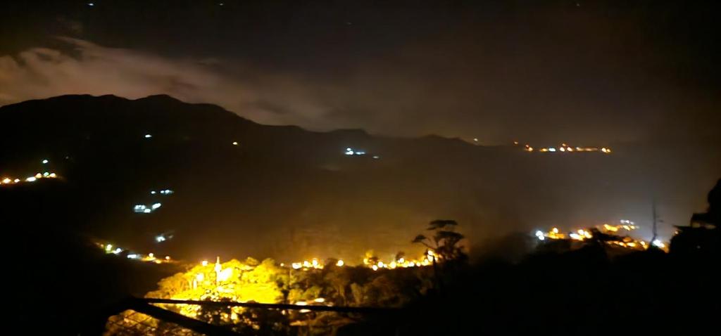 a view of a city at night with lights at Villa colibrí in Piñas