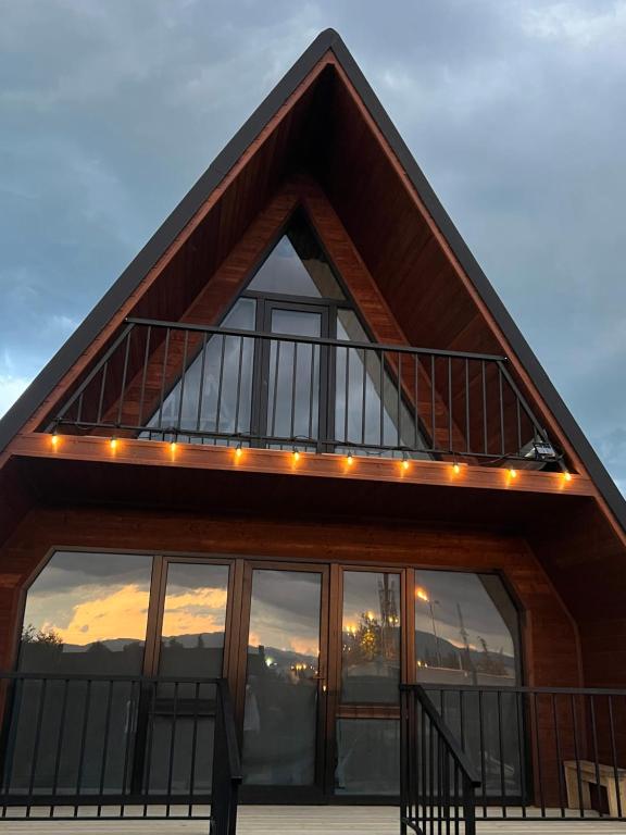 a house with a balcony with lights on it at Nakas cottage in Tbilisi City