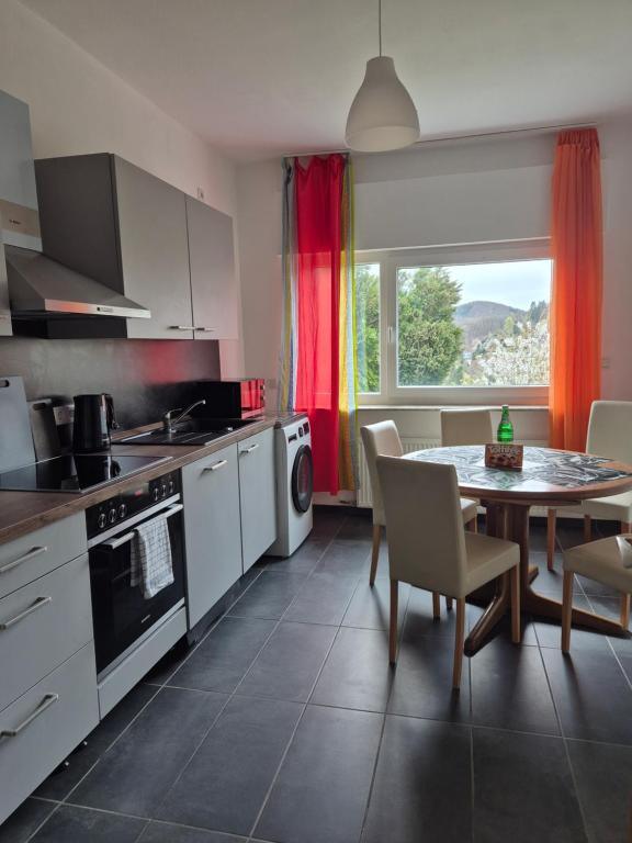 a kitchen with a table and a dining room at Monteurwohnung Biedenkopf in Biedenkopf