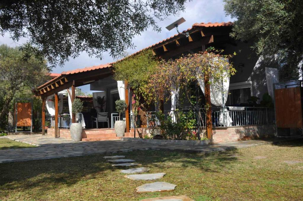 a house with a pergola in a yard at Georgias house in Yerakiní