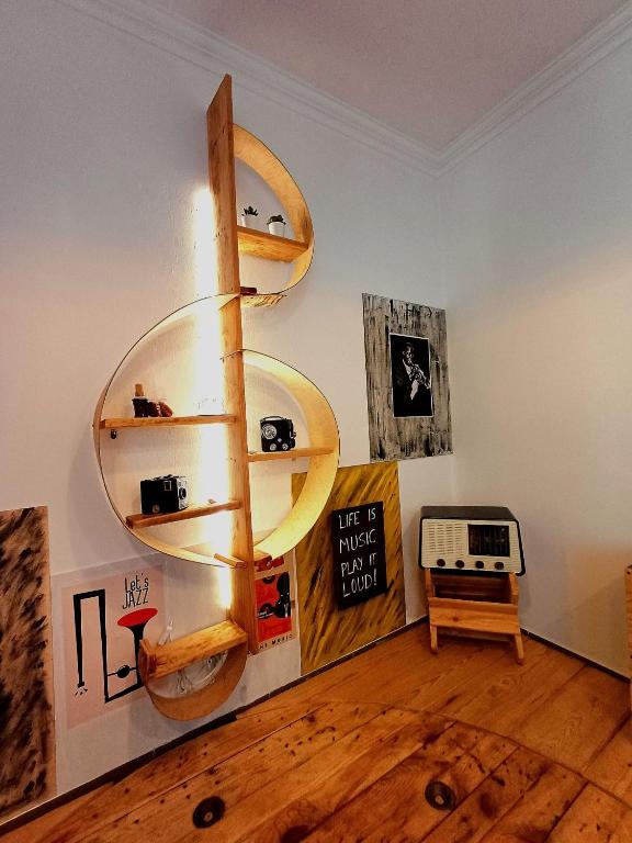 a living room with a wooden floor and shelves at Casa 40th-Music Wood House in Óbidos