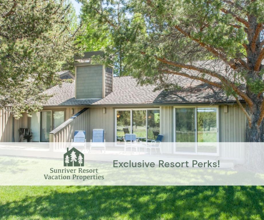 a house with a summer resort vacation properties sign at 108 Quelah Condo in Sunriver