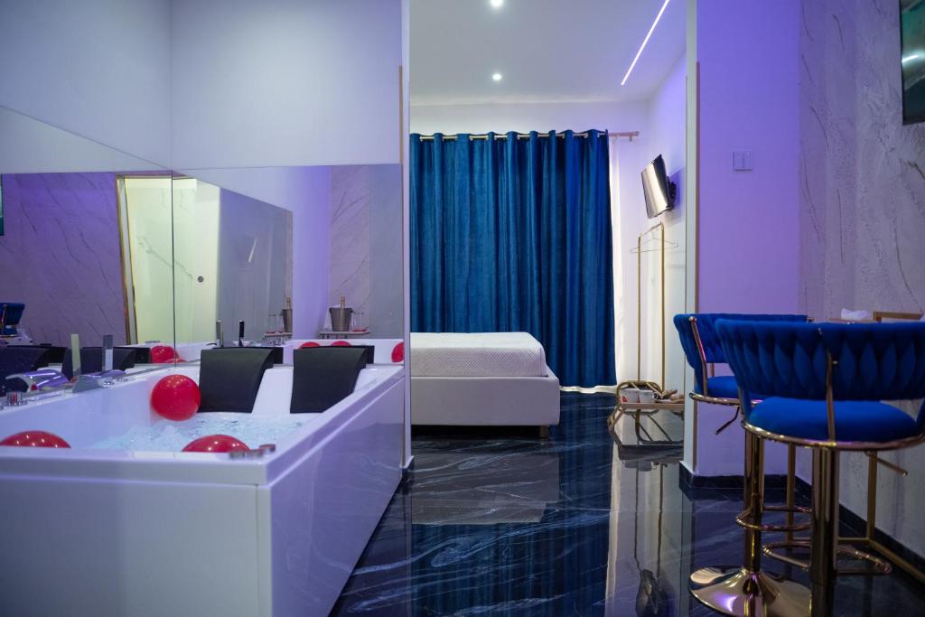 a living room with a couch and a blue chair at OLD STREET Luxury suite in Avola