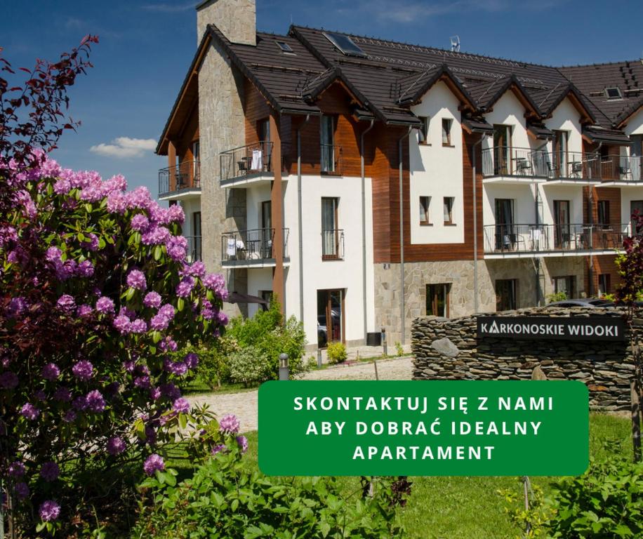 a building with a sign in front of it at Karkonoskie Widoki Apartamenty in Karpacz