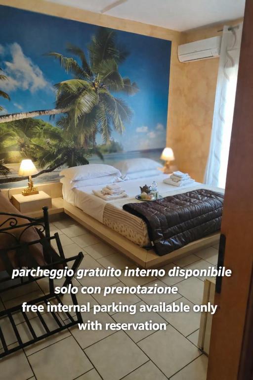 a room with a bed with a palm tree mural at B&B Santa Sofia in Gravina di Catania