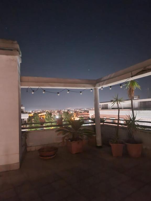 a view of a city from a balcony at night at Caty House in Nettuno