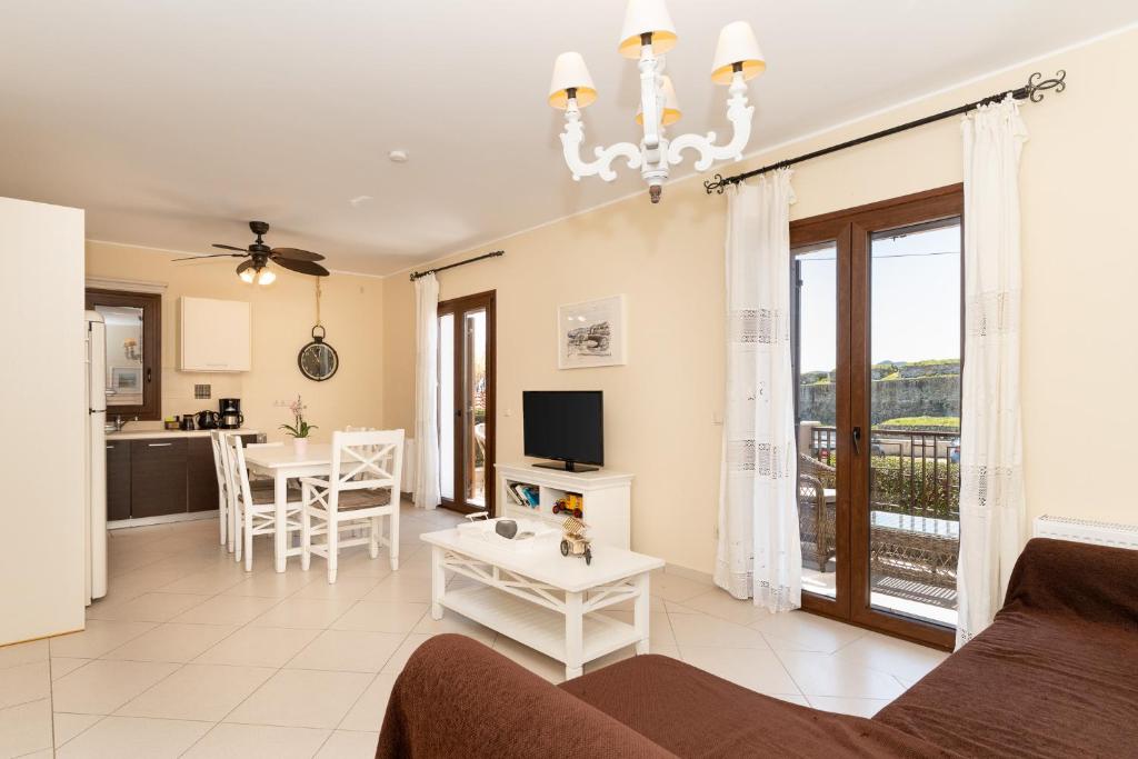 a living room with a couch and a table at Iliodysi Houses in Methoni