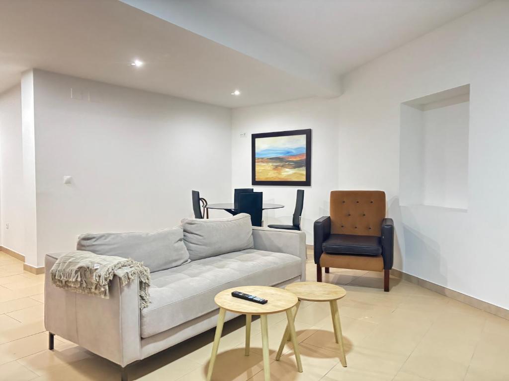 a living room with a couch and a chair at Desconectaengalicia Carlos Casas Playa Silgar in Sanxenxo
