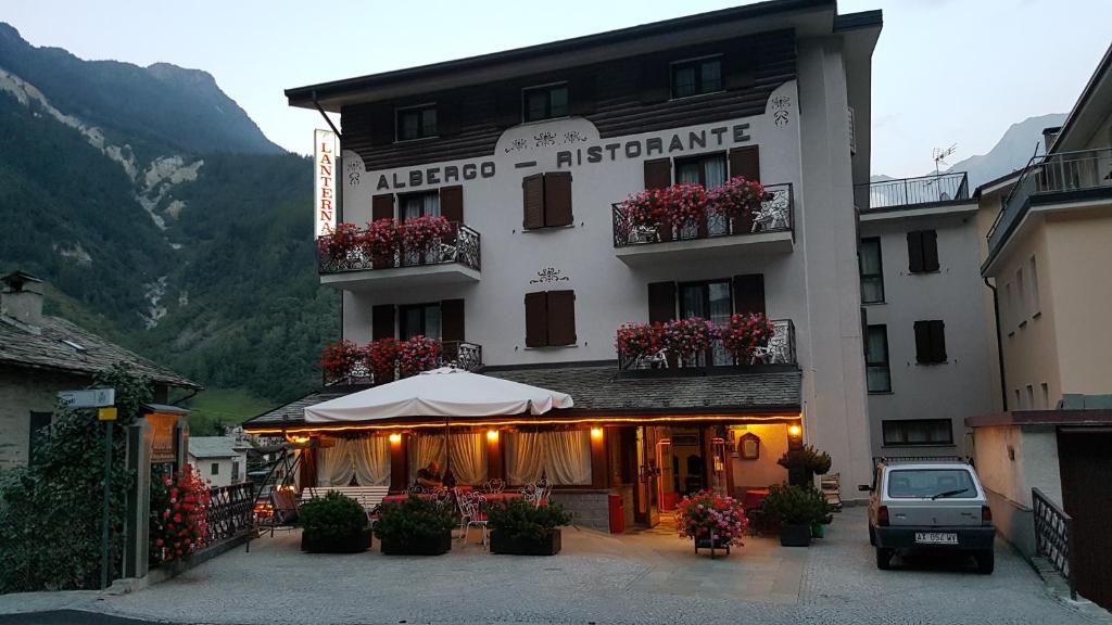 a large building with flowers on the balconies of it at Hotel La Lanterna in Chiesa in Valmalenco