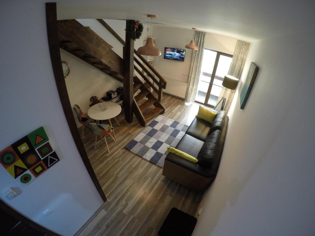 an overhead view of a living room with a mirror at Duplex Apartment Busteni in Buşteni