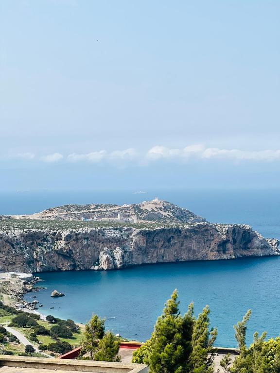 a view of a large body of water with an island at Belyounech in Belyounech 