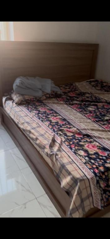 a bed with a quilt on top of it at Rehoboth compound in Lekki
