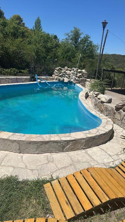 a swimming pool with a slide in the middle at Posada Bella Vista 1 y 2 in El Volcán
