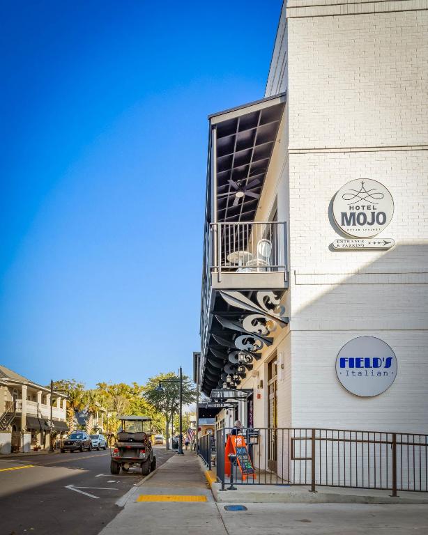 a building with a sign on the side of a street at Hotel Mojo in Ocean Springs