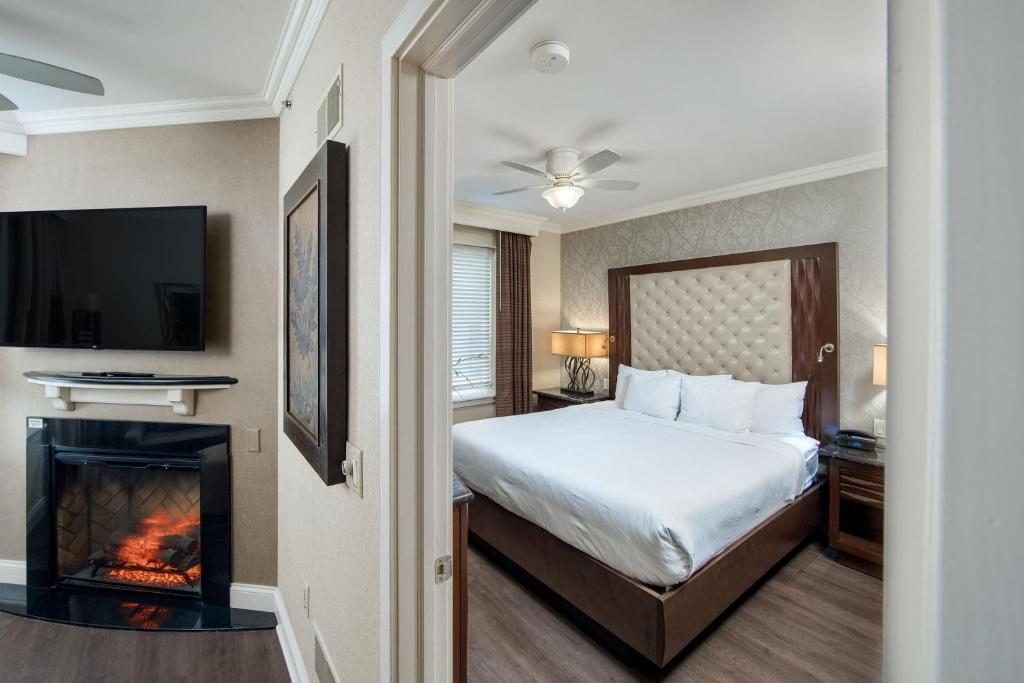 a hotel room with a bed and a fireplace at Eden Resort and Suites, BW Premier Collection in Lancaster