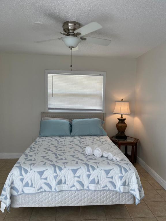 a bedroom with a bed with a ceiling fan at Dolphin Cove in Sarasota