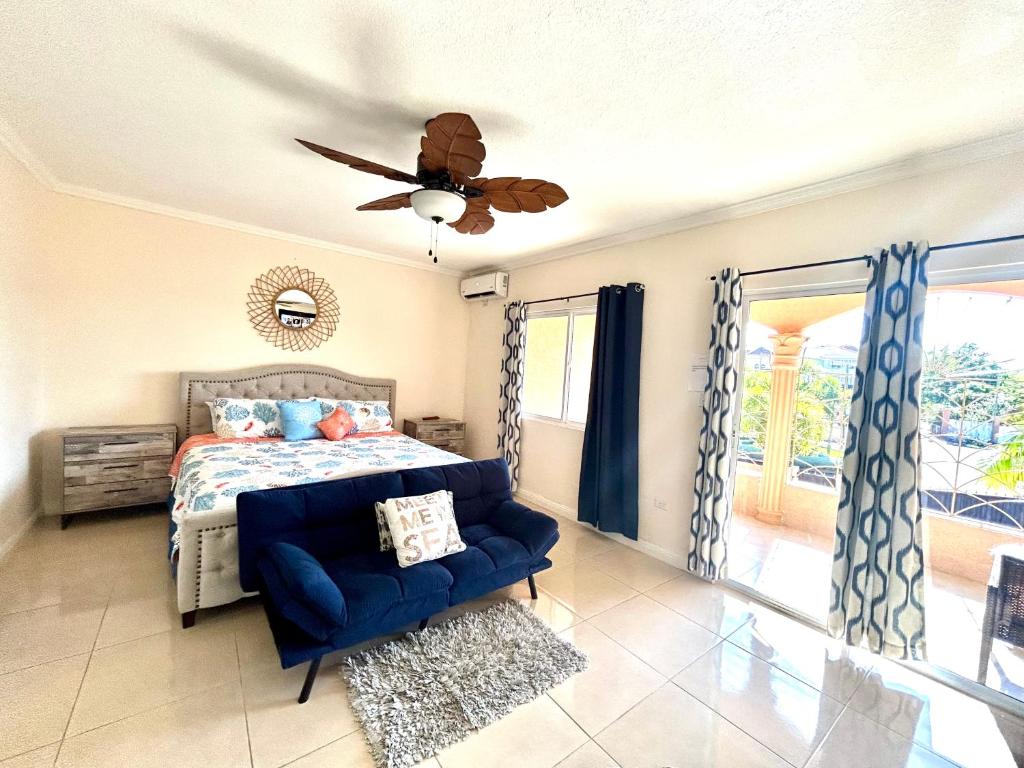 a bedroom with a bed and a ceiling fan at Palm Retreat in Ocho Rios