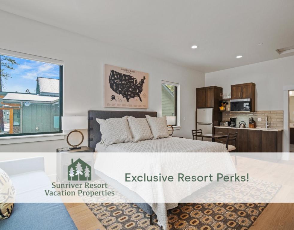 a bedroom with a large bed and a kitchen at 18171-2 Forestbrook Loop in Bend