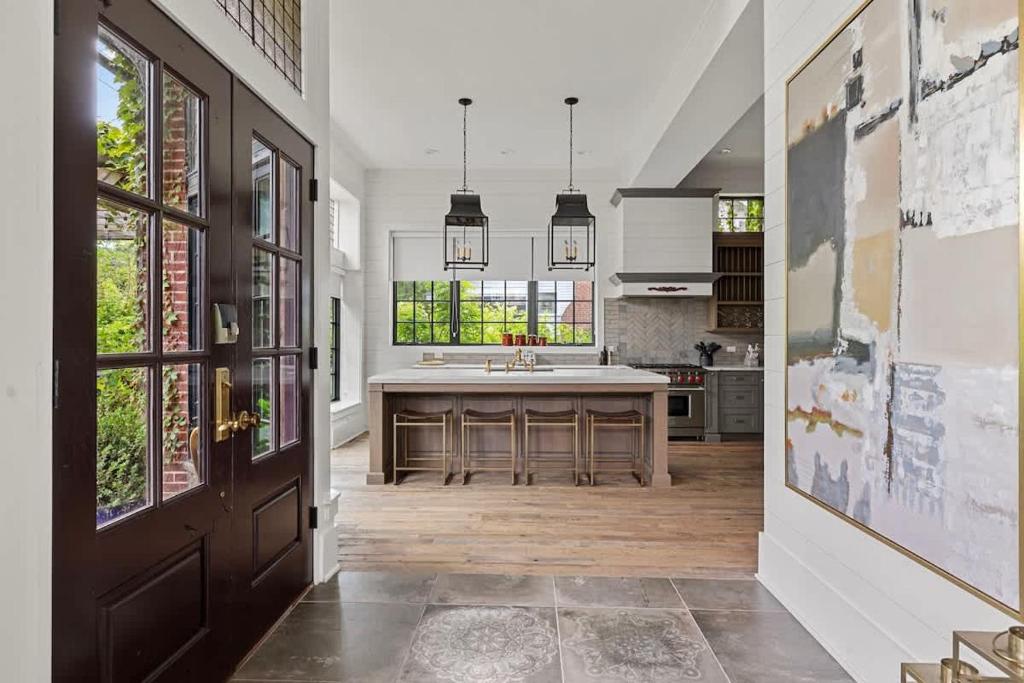 a kitchen with a large island in the middle at Black Door Bungalow by Juniper Holiday + Home in Lakeside