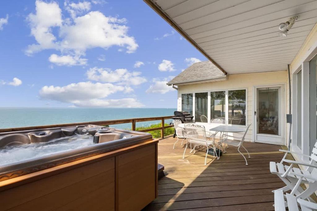 a kitchen with a view of the ocean from the deck of a house at Lake Michigan Getaway by Juniper Holiday + Home in New Buffalo
