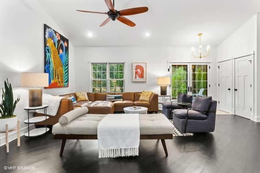 a living room with a couch and a ceiling fan at The Dakota by Juniper Holiday + Home in Union Pier