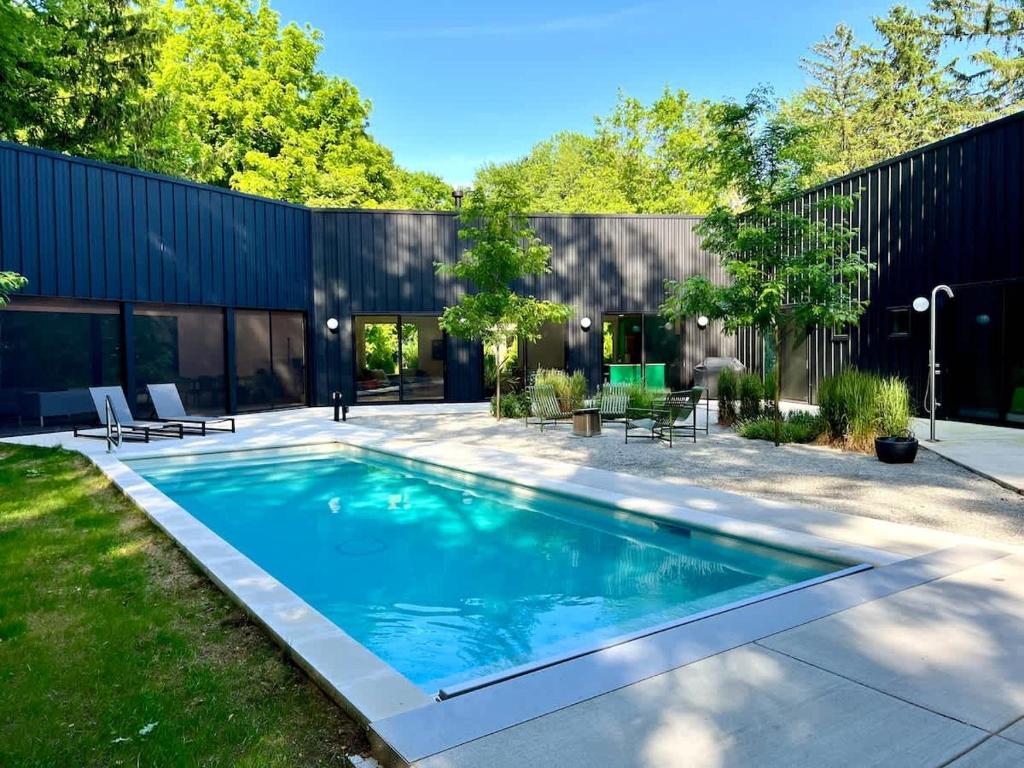 a swimming pool in the backyard of a house at Owlwood by Juniper Holiday + Home in Harbert