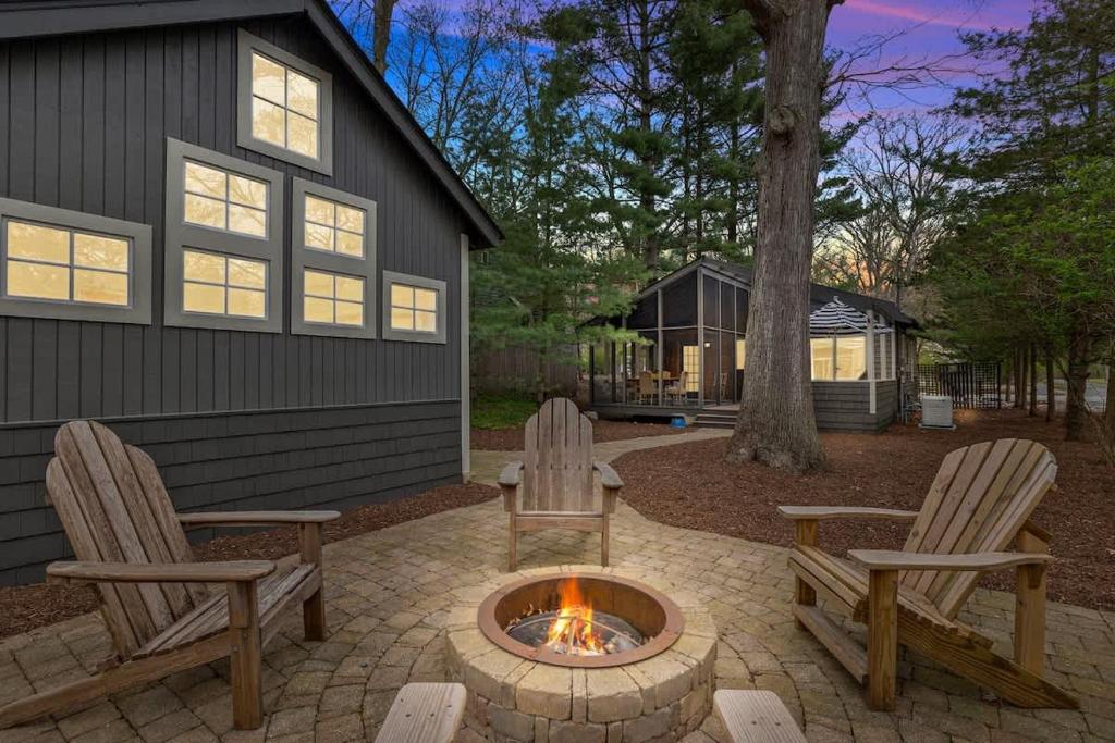 two chairs and a fire pit in front of a house at Meadow Pines by Juniper Holiday + Home in Michigan City