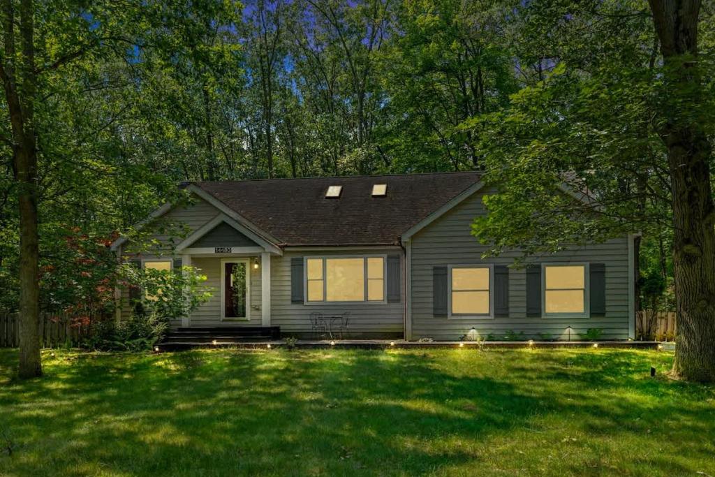 a house with a green lawn in front of it at The High Life by Juniper Holiday + Home in New Buffalo
