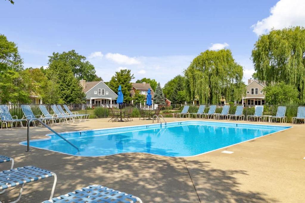 a large swimming pool with chairs at Schoolhouse Rock by Juniper Holiday + Home in New Buffalo