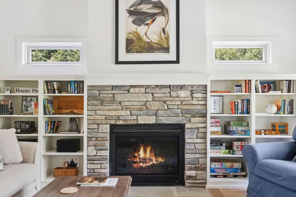 a living room with a fireplace and a couch at Greystone Cottage by Juniper Holiday + Home in Union Pier