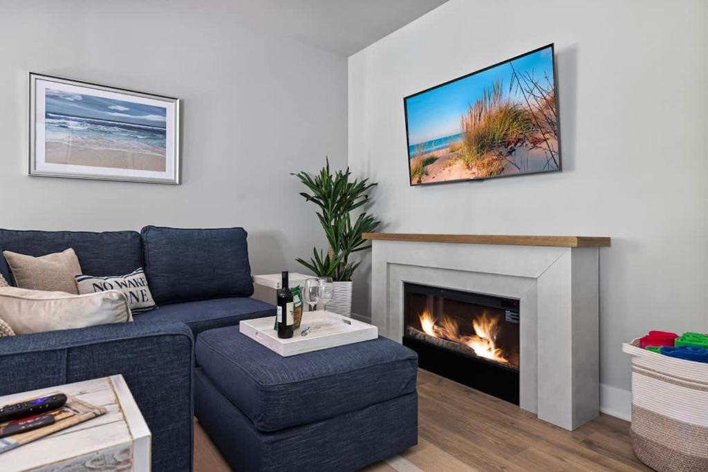 a living room with a couch and a fireplace at Sandy Shores in South Haven