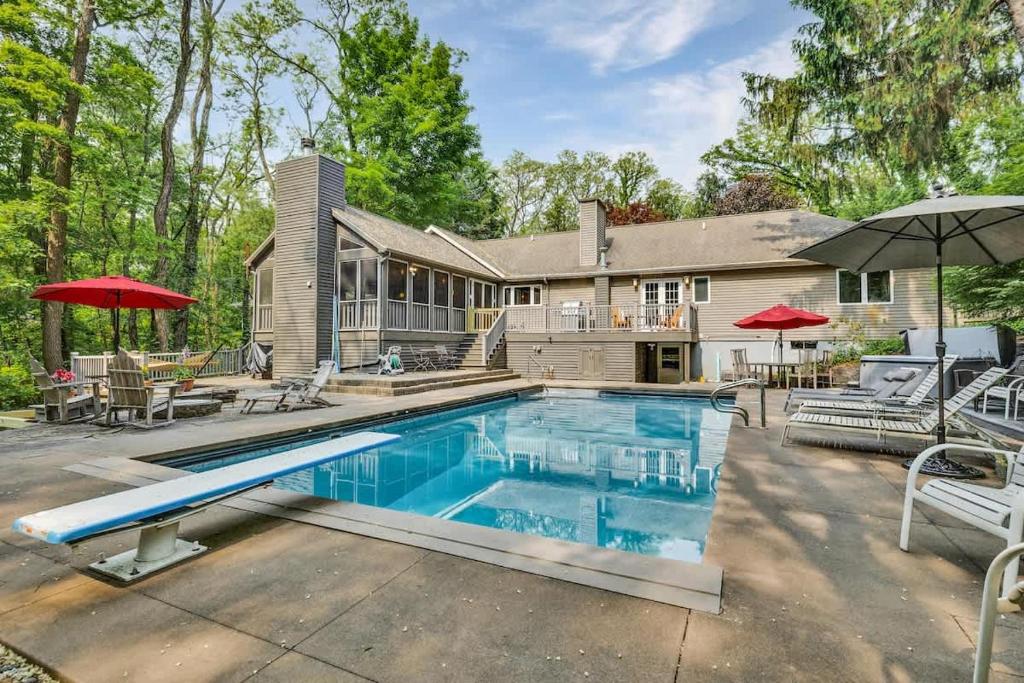 a swimming pool in front of a house at Hearth & Timber in Bridgman