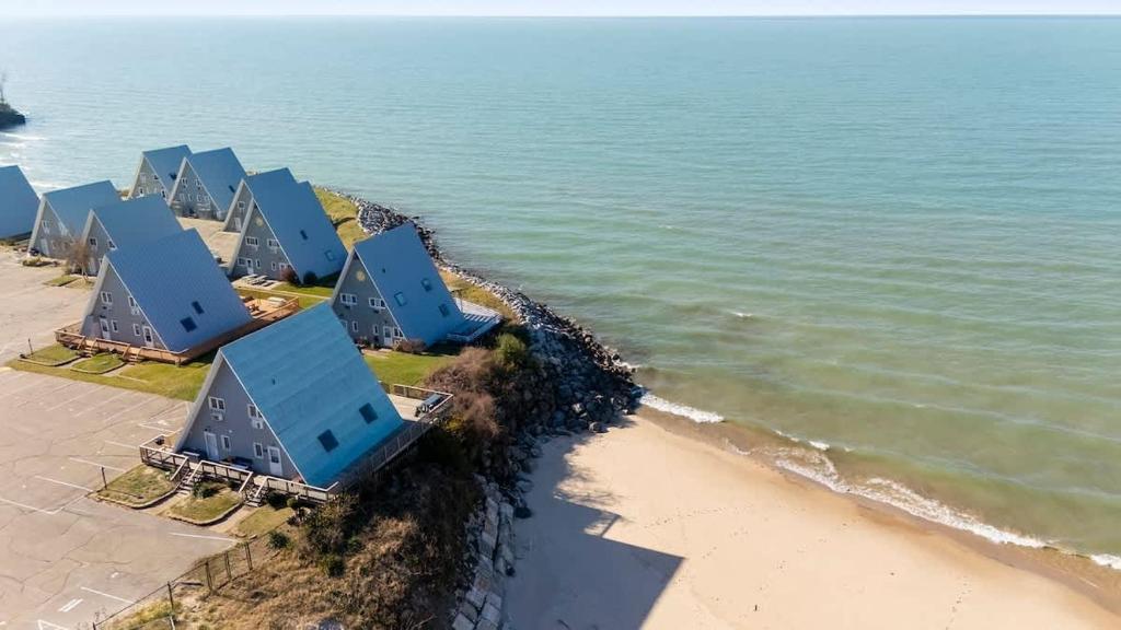 an aerial view of a row of blue buildings on the beach at Leilas Chalet in Stevensville